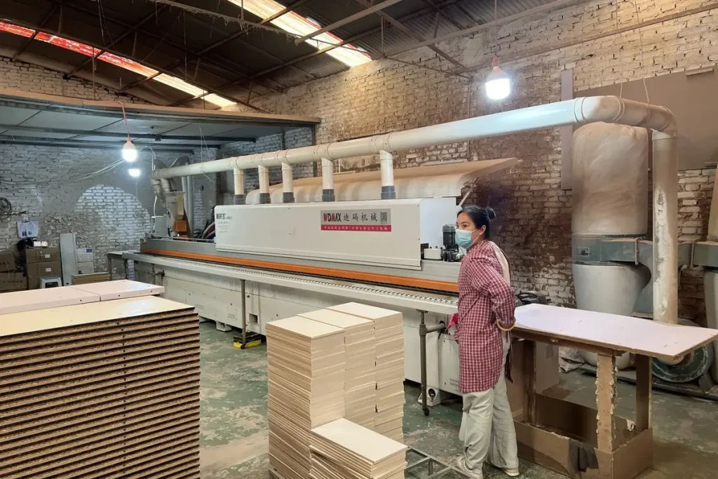 Panel furniture machining equipment and stacked boards inside a furniture factory