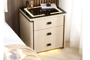 Smart nightstand beside a bed with lighting, wireless charging surface, headphones, and integrated Bluetooth speaker function