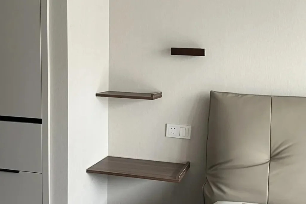 Hotel bed headboard wall with bedside power position and floating shelves for project furniture layout review