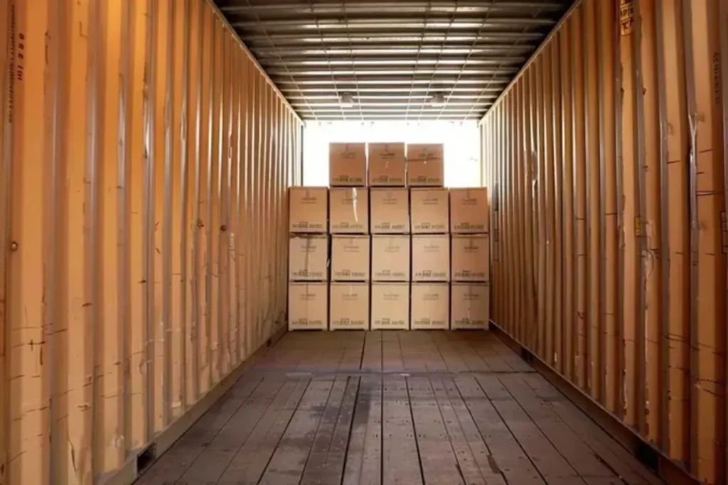 Export cartons loaded in a container for bedside furniture shipment, repacking review, and delivery protection checks