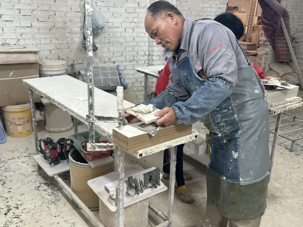 Furniture factory worker carrying out an in-process review of cabinet components