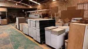 Stacks of prepared cabinet panels in a furniture factory staged for the next production step