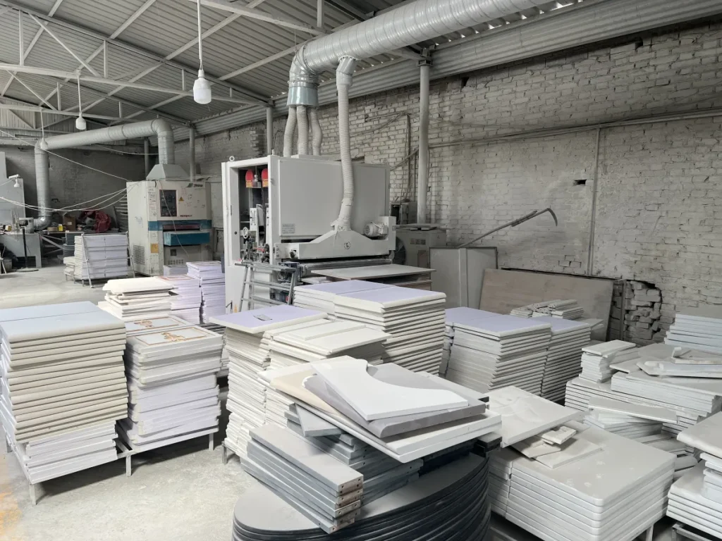 Different cut and finished cabinet panels stacked in a furniture workshop
