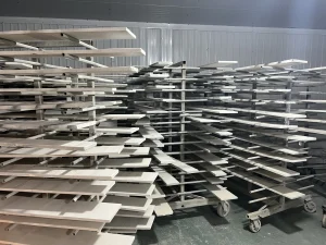 Furniture panels on factory drying racks after finishing, ready for colour and surface checks